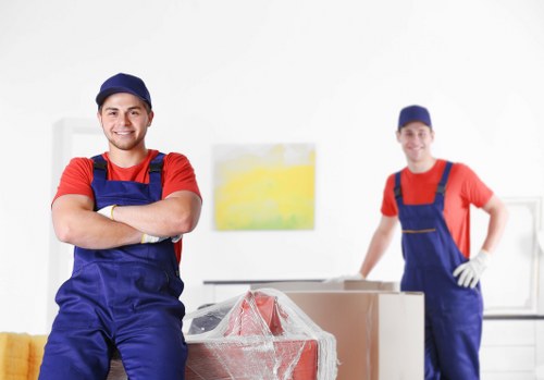 Local removals crew handling furniture in a Finchley property