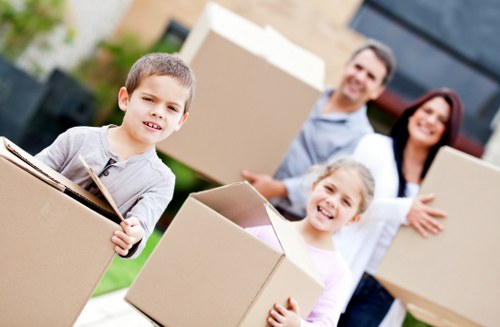 Unpacking services in Finchley helping arrange items in a new home