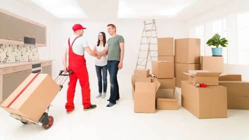 Moving boxes and furniture being loaded for a North London house move